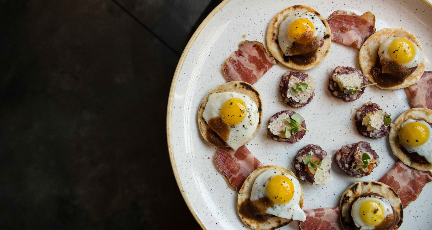 An appetizer with eggs, meat