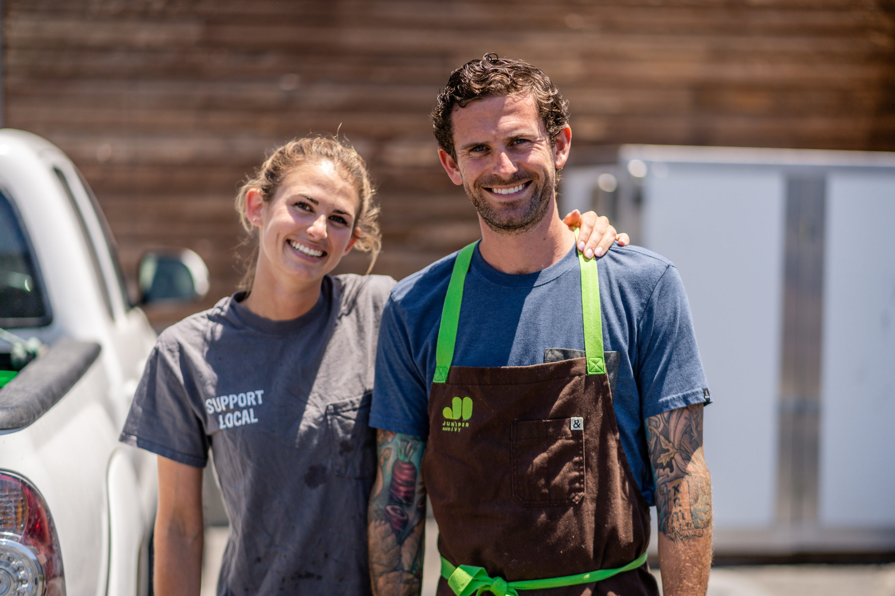 woman and man smiling, woman has arm around juniper and ivy chef