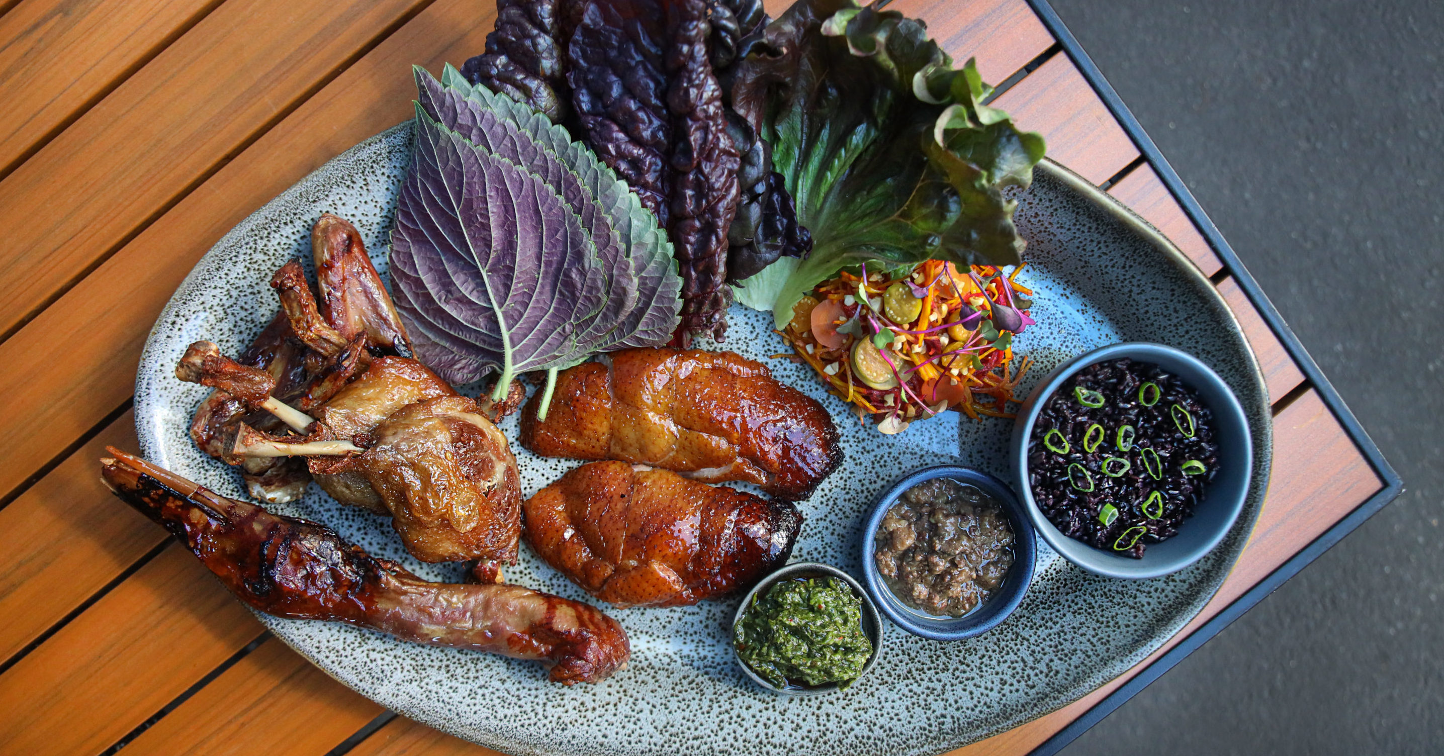 Plate of whole duck on brown table
