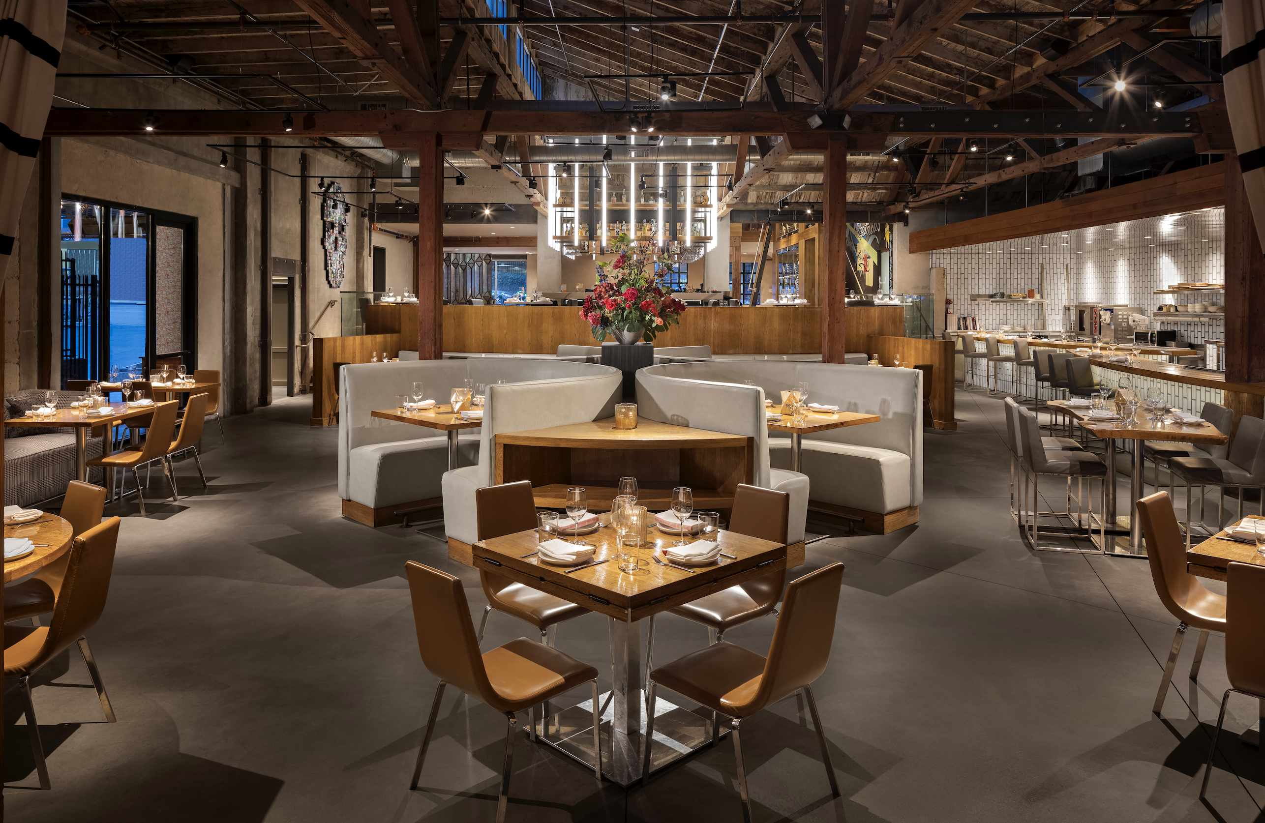 View of dining room showing multiple tables and booths set for dinner