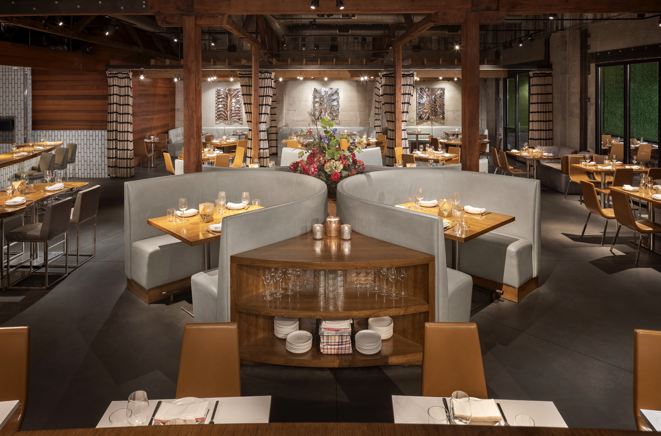 Overview of empty main dining room with booths, tables, and barstool seating